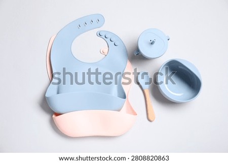 Set of baby tableware on light grey background, flat lay