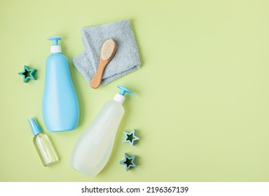 Set Of Baby Toiletries, Child Organic Hygiene And Bath Accessories, Shower Gel, Shampoo, Essential Oil, Towel On Green Pastel Background. Top View, Flatlay