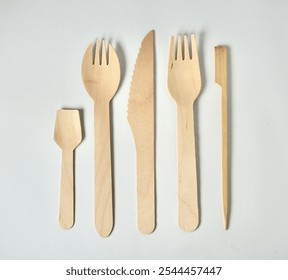 Set of bamboo wooden kitchenware eating utensil spoon, spork, fork, knife, and skewer stick object with no food isolated on horizontal white background. - Powered by Shutterstock