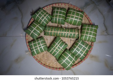 Set of "Banh Chung" or Chung cake put on flat winnowing basket