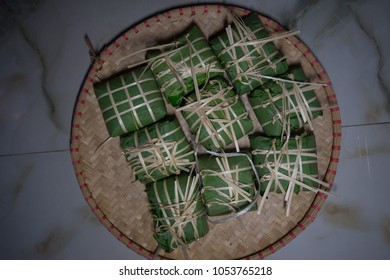 Set of "Banh Chung" or Chung cake put on flat winnowing basket