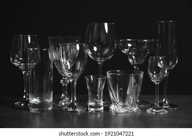 Set Of Bar Glassware On Table Against Dark Background