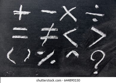 Set of basic math symbol draw by white chalk on blackboard background