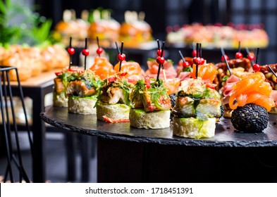 Set Of Beautiful Canapes On Black Stone Plates. Buffet Table. Catering.