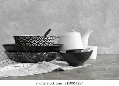 Set of beautiful dinnerware on light grunge background