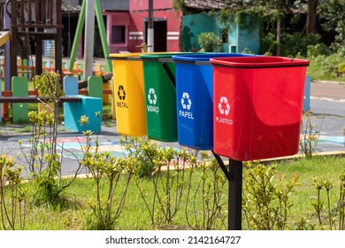 Set of bins for the selective collection of waste (metal, glass, paper, and plastic), in portuguese,  for recycling purposes.