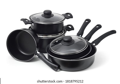 Set of black non-stick kitchen utensils on a white background. Pot, ladle, frying pan  with glass lid.