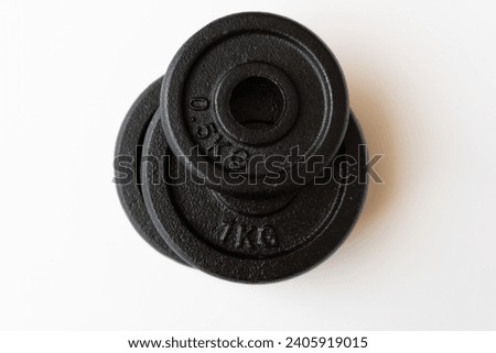 a set of black weights for exercises of various weights on white background
