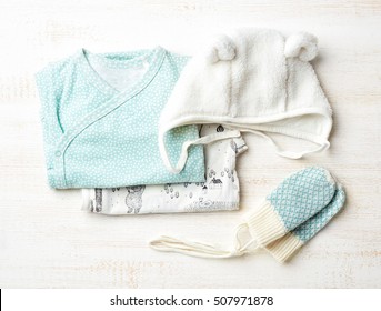 Set Of Blue Baby Clothes On Wooden Background, Top View