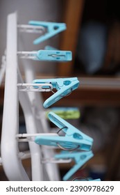 a set of blue scissors hanging from a rack.