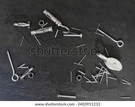 Set of bolts nuts nails metal fasteners. Consumable hardware tools. assortment steel screws collection close up background