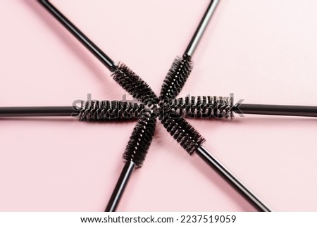 Set of brushes for eyelashes and eyebrows on pink background. Correction and care. Cooling and laying. Womens cosmetics.
