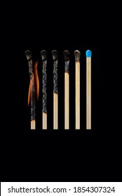 A set of burnt matches from completely burnt to whole, isolated on a black background. The concept of different stages of development, being in different stages.