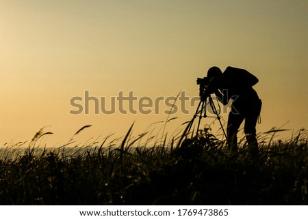 Set the camera to capture the sunset.