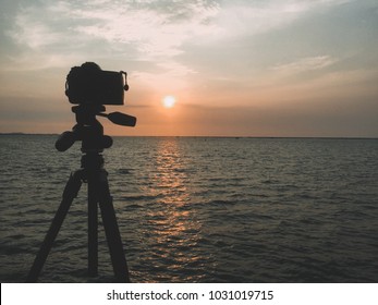 Set Up Camera On Tripod Shooting Sunset Over The Sea Space For Text