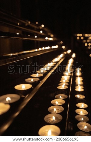 set of candles lit in a European cathedral. Request for religious wishes