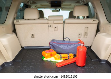 Set For A Car From A Fire Extinguisher, Tow Rope, Tool Kit And Medical Kit In The Trunk Of An Off-road Vehicle.