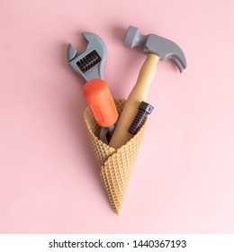 Set of carpentry tools in ice cream cone isolated on pastel pink background minimal creative concept.