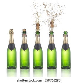 Set of champagne bottles with popping corks . Isolated on white background