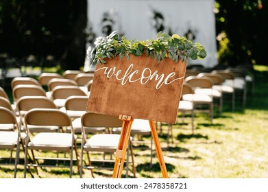 Set a charming mood at your outdoor wedding with a welcome sign and chairs for a beautiful ceremony - Powered by Shutterstock