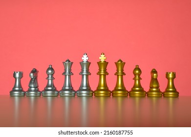 Set Of Chess Figures In A Row Isolated On A Red Background