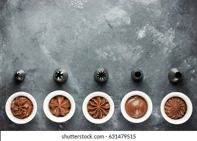 Set Of Chocolate Cream Swirl And Metal Nozzles For Confectionery Bag Top View