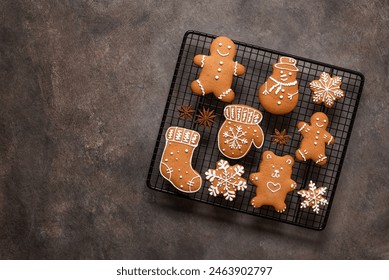 Set of Christmas gingerbread cookies on a cooling rack, brown rustic background. Top view, flat lay, copy space. - Powered by Shutterstock