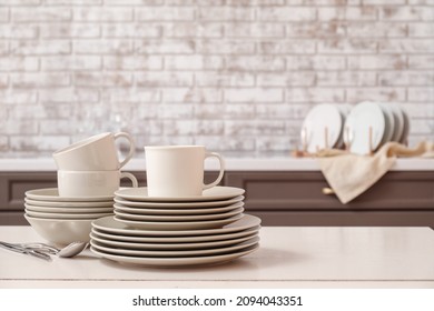 Set Of Clean Dishes On Table In Kitchen