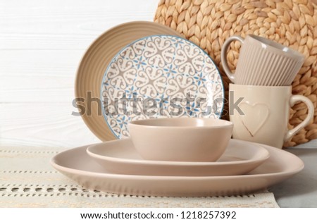 Set of clean dishware on table