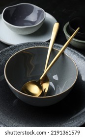 Set Of Clean Tableware On Black Table