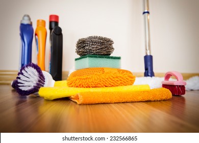 Set of cleaning equipment on a wooden floor