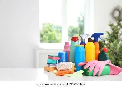 Set of cleaning supplies on table indoors - Shutterstock ID 1121950106