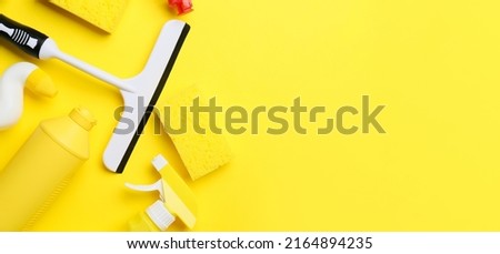 Set of cleaning supplies on yellow background with space for text
