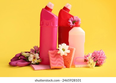 Set of cleaning supplies and spring flowers on yellow background - Powered by Shutterstock