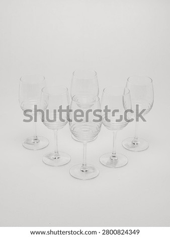 Set of clear glass stemware goblets isolated on white background.