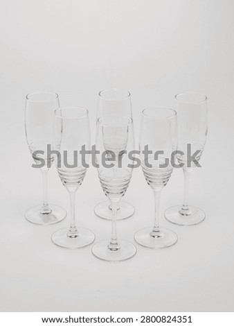 Set of clear glass stemware goblets isolated on white background.
