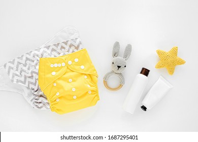Set of cloth diaper, baby cosmetics and child stuff.  Eco friendly cloth nappies for newborn. Baby hygiene concept.  Flat lay, top view