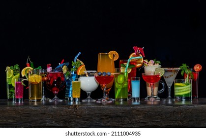 Set Of Coctails On Bar Counter In A Restaurant, Pub. Collection Of Fresh Juice Alcoholic Drinks. Cooler Beverage Isolated On Black Background.