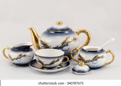A set of coffee cups, sugar bowl, jug. Set coffee with the design of a dragon. Blue, white and gold.
