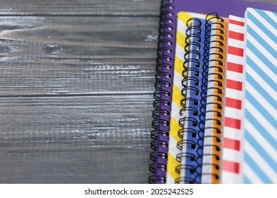 Set of colored notebooks on gray wooden table. Back to school,  preschool education.	Close up - Powered by Shutterstock - Get 15% off with code: PIKWIZARD15