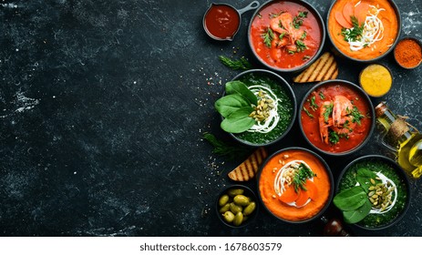 Set Of Colored Soups. Spinach Soup, Tomato Cream Soup And Carrot Puree Soup. Healthy Food. On A Black Stone Background.