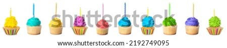 Set of colorful birthday cupcakes with candles isolated on white