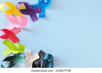Set of colorful cancer awareness ribbons flat lay in blue background. World Cancer Day concept.	 - Shutterstock ID 2156577749
