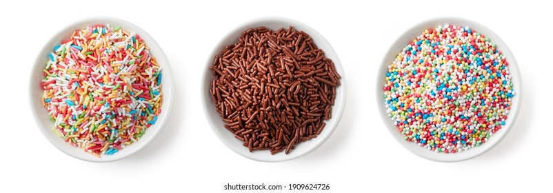 Set of colorful and chocolate candy sprinkles in white bowl isolated on white background, top view