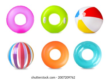 Set with colorful inflatable rings and balls on white background 