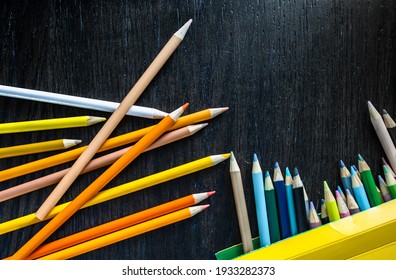 Set Of Colorful Pencils On Wood Texture Background, Group Of Warm Tone Color Flat Lay Outside A Yellow Paper Box With Copy Space. Elementary Education Of Art Class For Children. Imagination Concept.