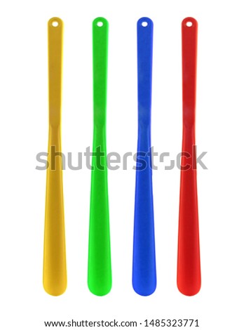 Set of colorful Shoehorns isolated on white background. There is orange, green, blue and red long spoon.