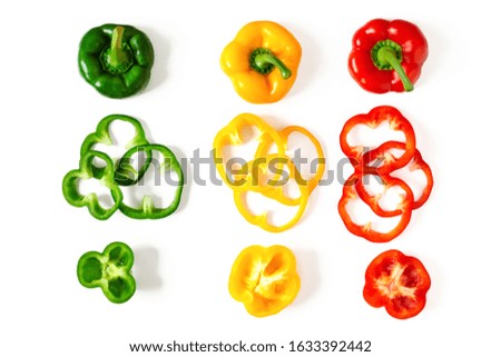 Set of colorful sliced bell pepper isolated on white background top view. Slices of red, yellow and green bell pepper.