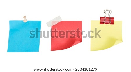 set of colorful sticky notes with pushpin, tape and paper clip. red, blue and yellow sticky notes with curled up edge isolated on white