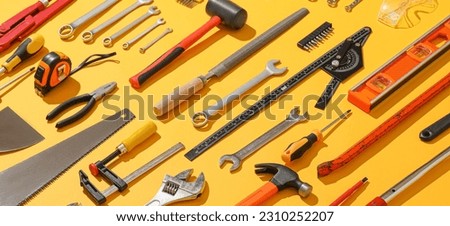 Set of construction tools on yellow background